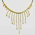 A gold-toned statement necklace with a textured curved top band and multiple dangling fringe chains, displayed against a plain white background.