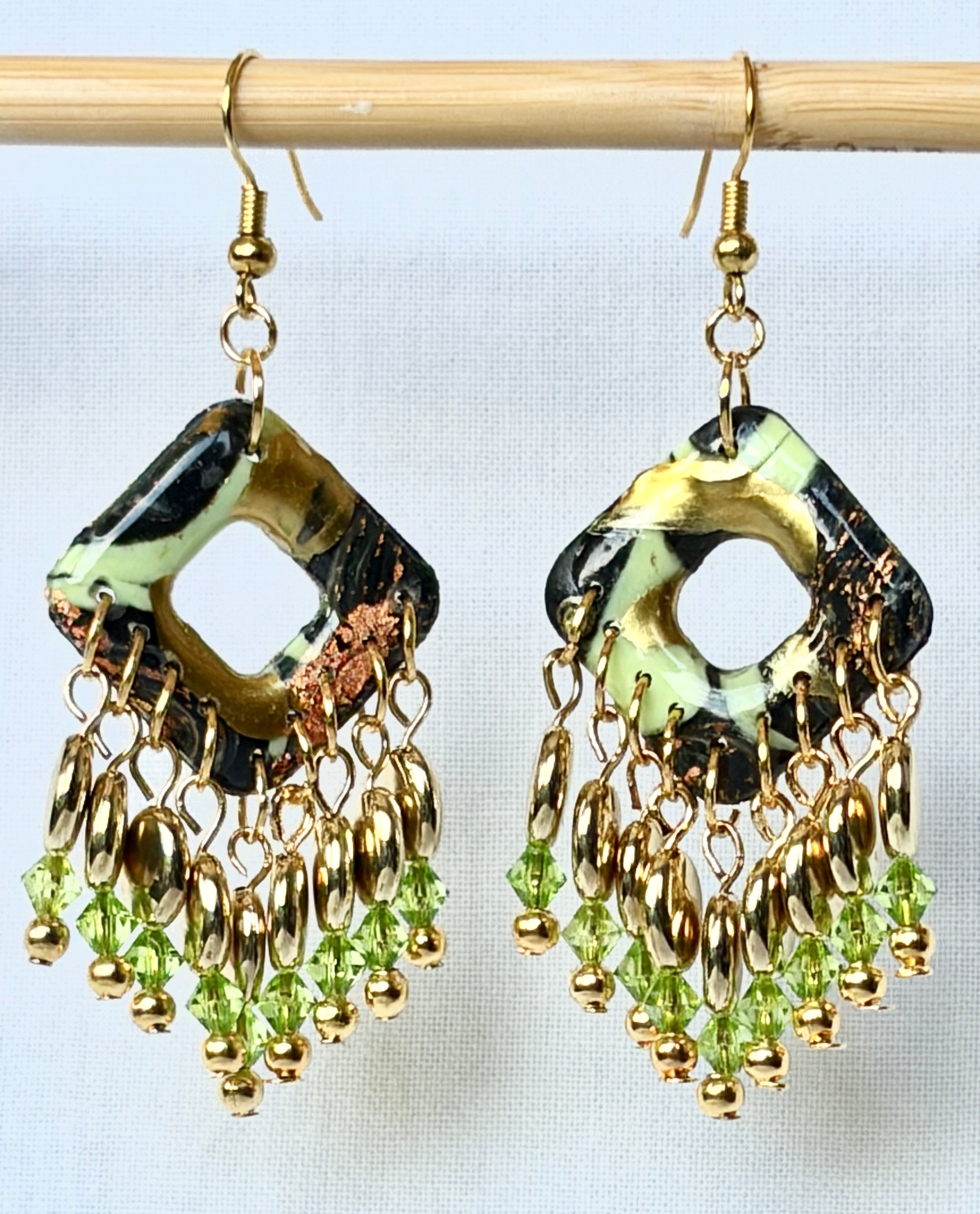 Dark green and black polymer clay open diamond chandelier earrings with gold and peridot green crystal bead fringe